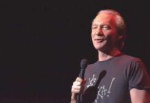 Bill Maher Challenges His Own Party Again comedian holding a microphone on stage