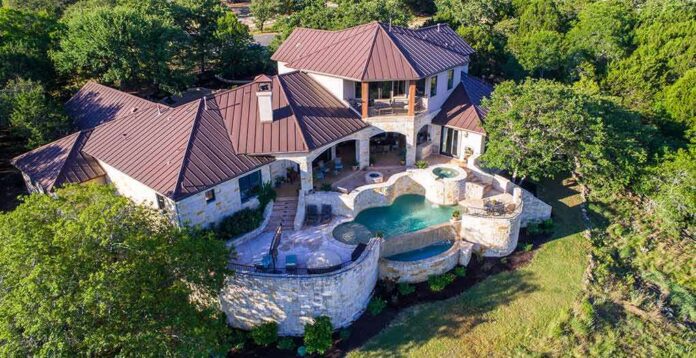 Luxury hillside stone mansion with tiered pool and spa