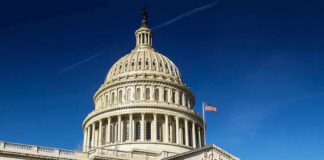 United States Capitol dome against clear blue sky