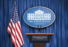 White House press briefing podium and US flag