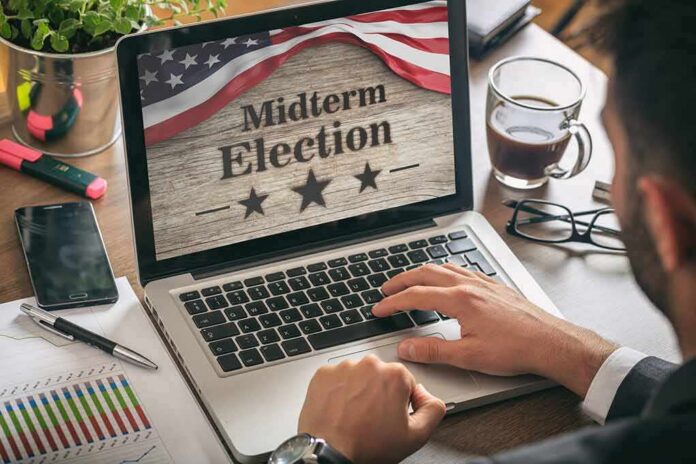 Person using laptop displaying midterm election screen