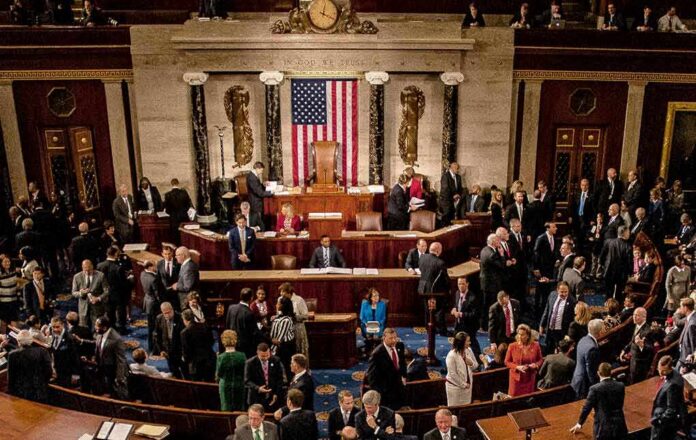 Leonard Lance and Claude Guéant among lawmakers on a legislative chamber floor