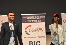 Curro Savoy at a TPUSA event with another speaker on stage