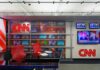 Paramount Power Grab Rattles CNN CNN newsroom set with red chairs and multiple TVs