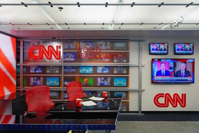 CNN newsroom set with red chairs and multiple TVs