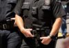 Police officers in black uniforms with duty belts