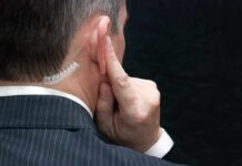 Radio Alerts, No Action – Why? Man in suit with earpiece touching his ear