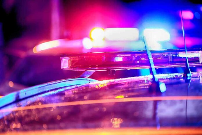 Police car light bar flashing at night