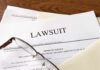 Legal documents labeled lawsuit on a desk
