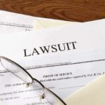 Legal documents labeled lawsuit on a desk