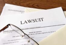 Legal documents labeled lawsuit on a desk