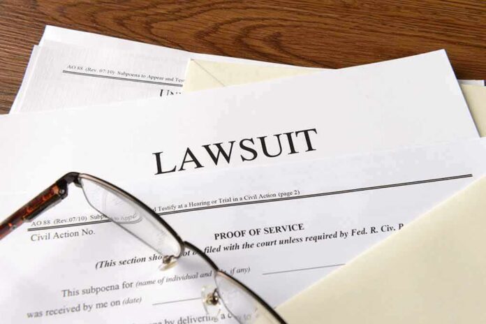 Legal documents labeled lawsuit on a desk
