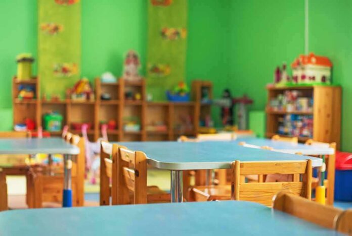Preschool classroom with small tables and wooden chairs