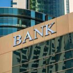 bank building exterior with glass and signage
