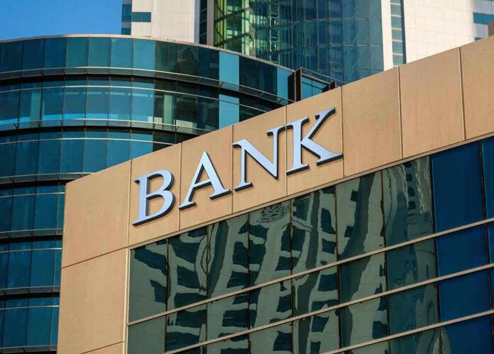 shutterstock_614911946 bank building exterior with glass and signage