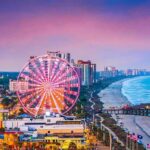 Ferris wheel on a beachfront city at sunset