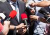 A White House Exchange Takes A Personal Turn Person in suit surrounded by microphones during media interview