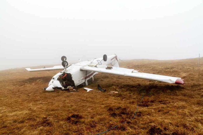 Crashed airplane lying on its side in a foggy field