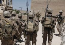 soldiers in desert fatigues with radio packs and antennas