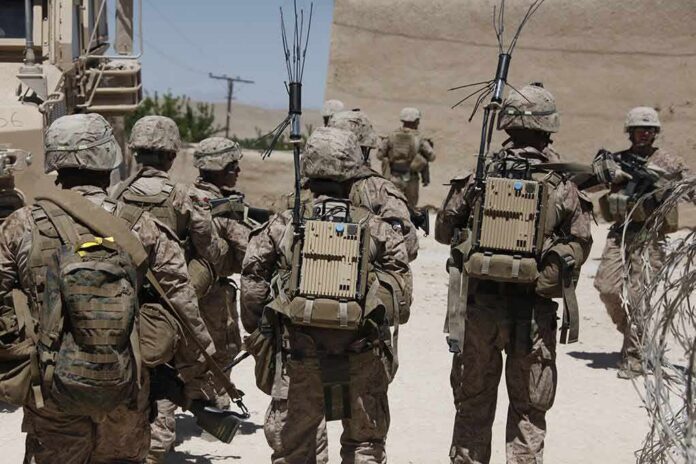 soldiers in desert fatigues with radio packs and antennas