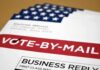 Mail-in ballot envelope with red vote-by-mail banner