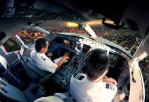 Air Force Flyby Rattles DC – Where Was Notice? Pilots in an airplane cockpit during city approach at sunset